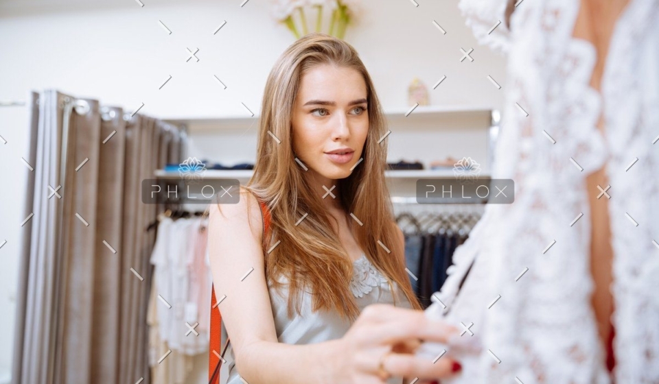 demo-attachment-141-woman-doing-shopping-and-choosing-clothes-in-PDEP6XU